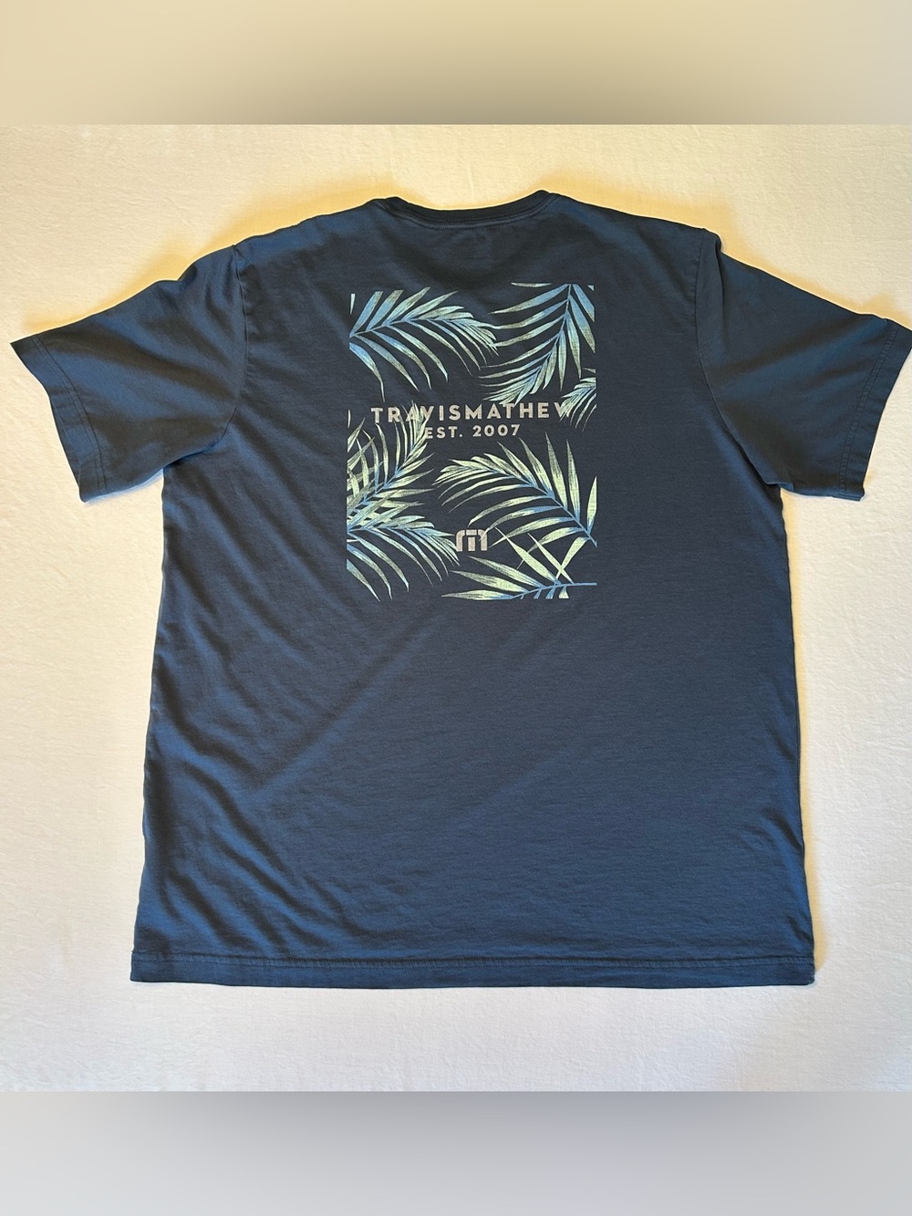 Travis Mathew Navy T-Shirt with Tropical Graphic Print